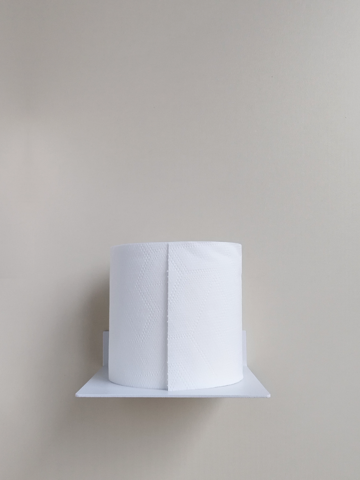 A white steel toilet roll holder in a ctm store in Johannesburg with bathroom decor from Mr Price Home