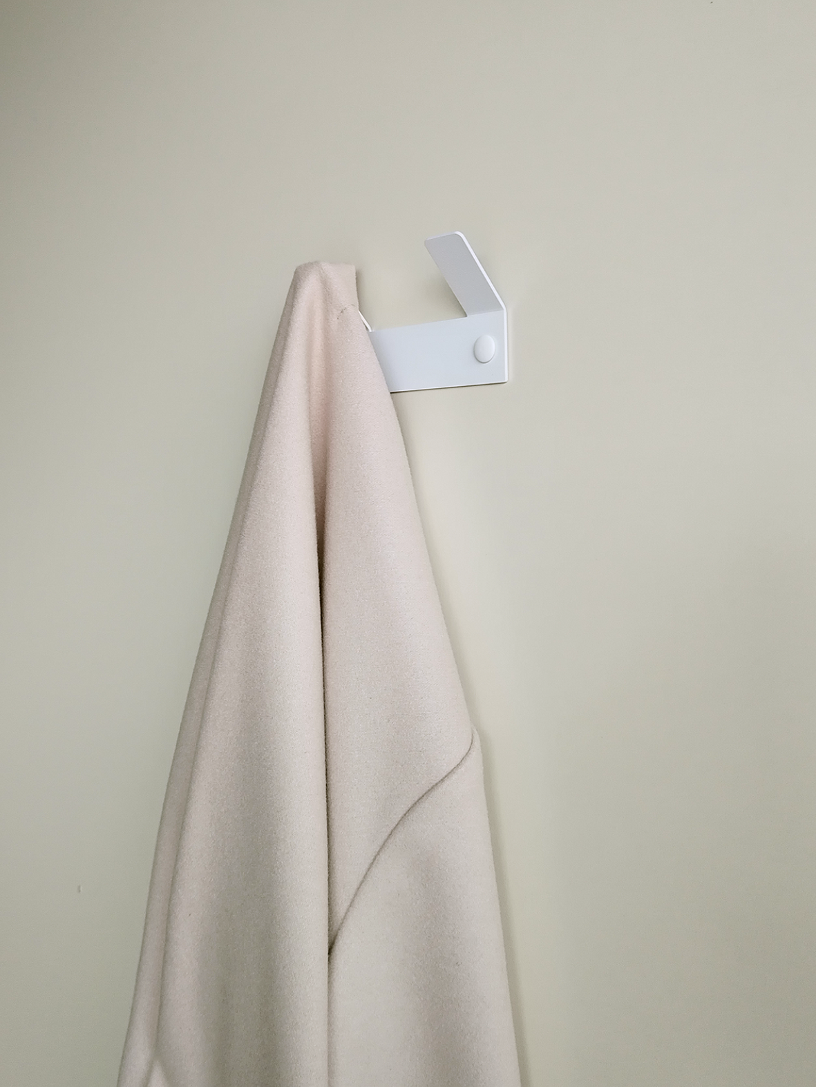 This double wall hook for hanging towels is in a minimal south african bathroom design.