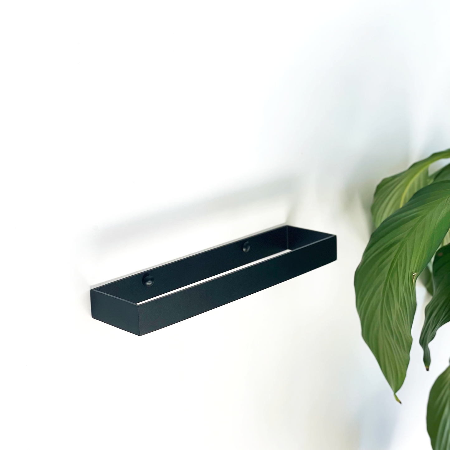 Modern black steel hand towel rail or black steel towel rack with indoor plant from Mr Price home