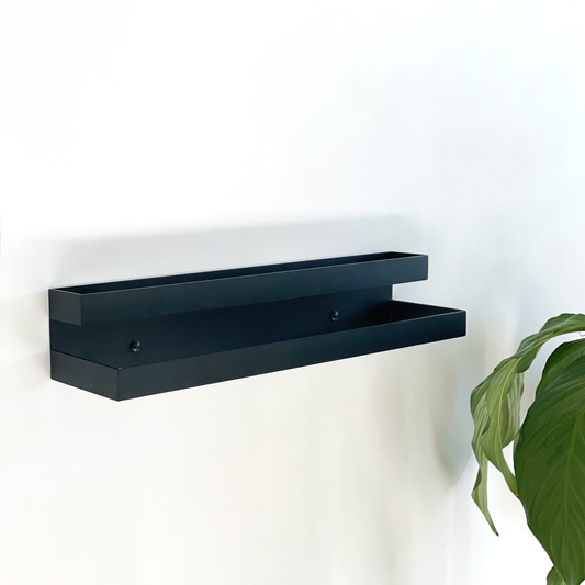 A Black steel towel ladder or a black steel towel rail in a modern bathroom design in a Joahnnesburg bathroom with an indoor plant