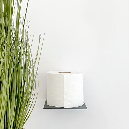 A black steel toilet roll holder in a ctm store in Johannesburg with bathroom decor from Mr Price Home